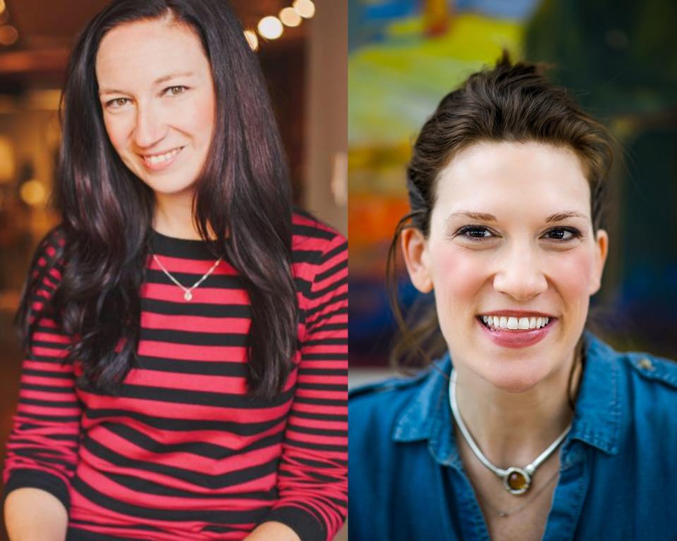 Two women with dark hair are sitting side-by side and smiling.