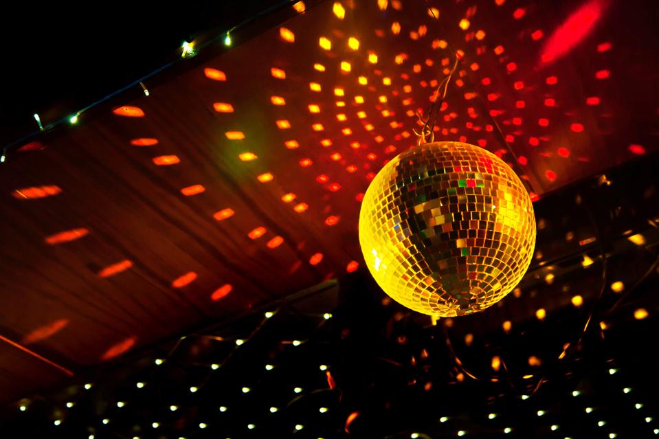Mirror disco ball with light reflection on the ceiling
