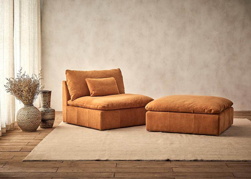 A brown leather chair and ottoman in a living room