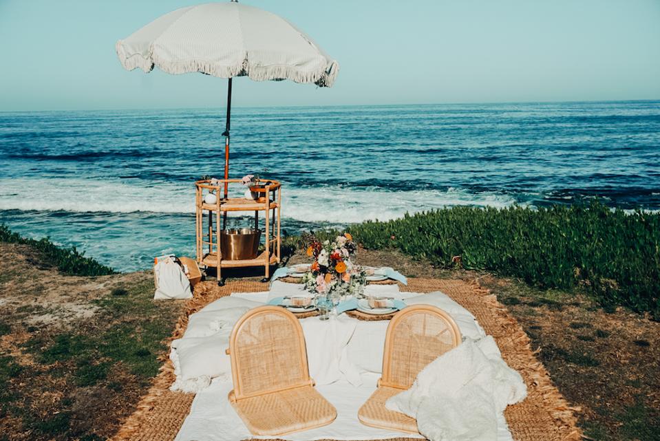 Lounge chairs and a bar cart with umbrella on the beach