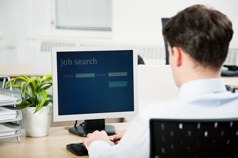 Office worker using computer to perform job search
