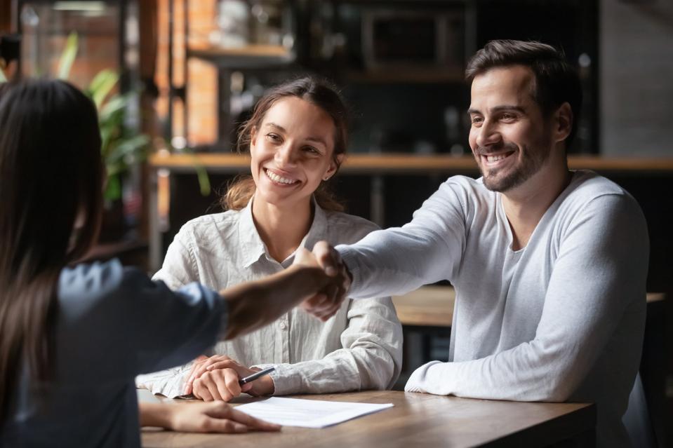 Happy couple handshake after deal.