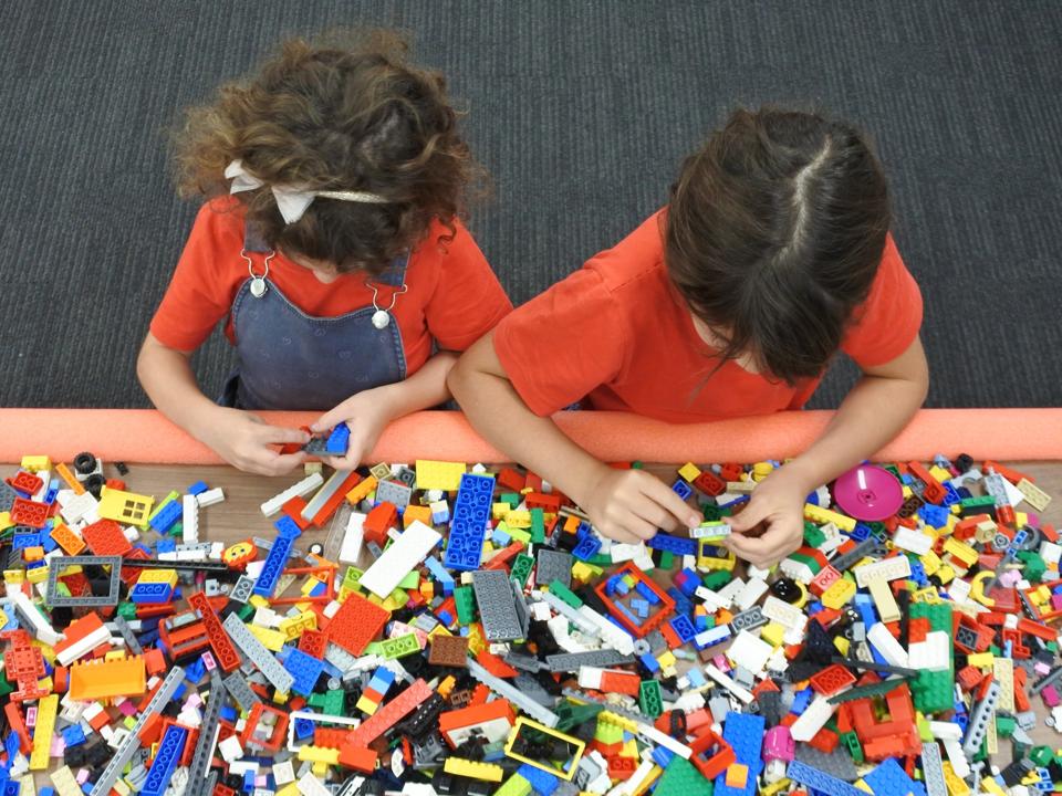 Two girls playing with building bricks