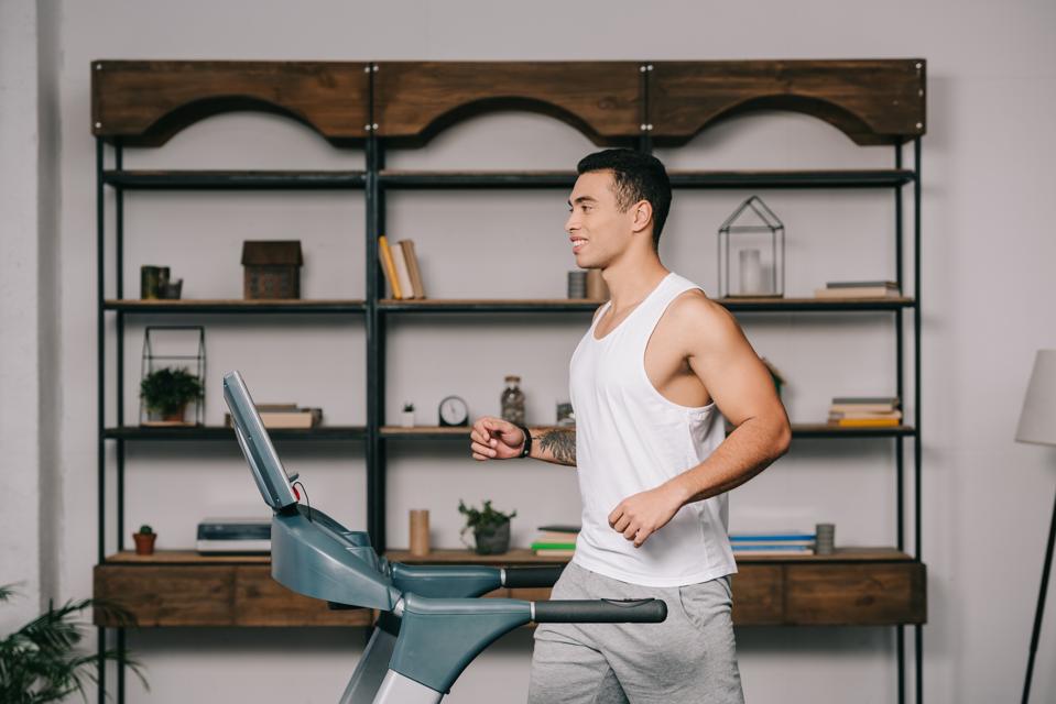 Young man on treadmill at home