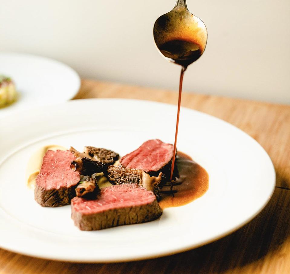 a lamb loin is delicately covered in a jus