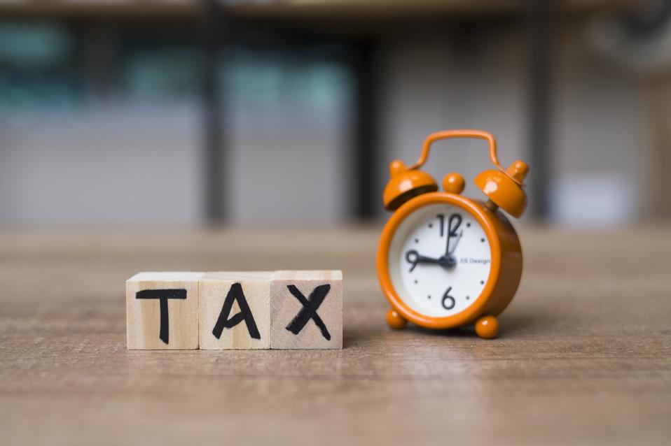 Tax Time Text on Adhesive Note on Alarm Clock