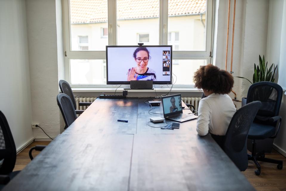 Businesswoman having a meeting with coworkers over a video call
