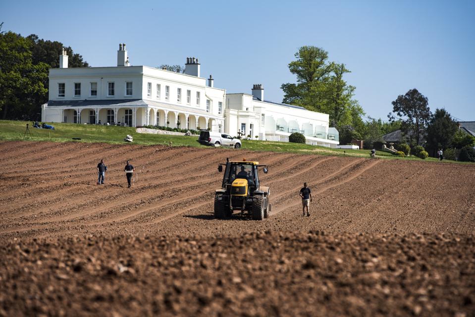 tractor in front of a mansion