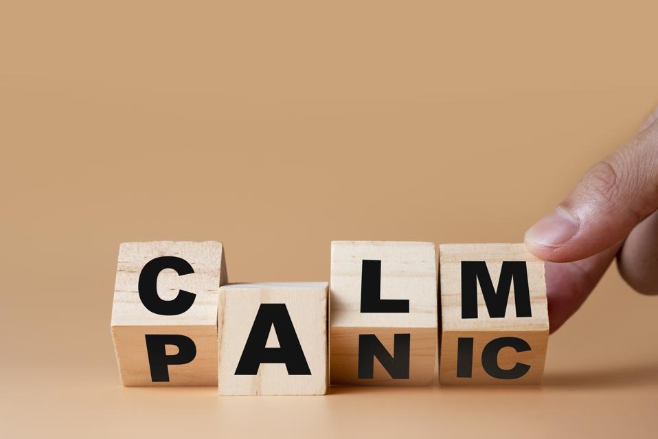 Hand flipping wooden cubes for change wording″ Panic ″  to ″ Calm″.  Mindset is important for human development.