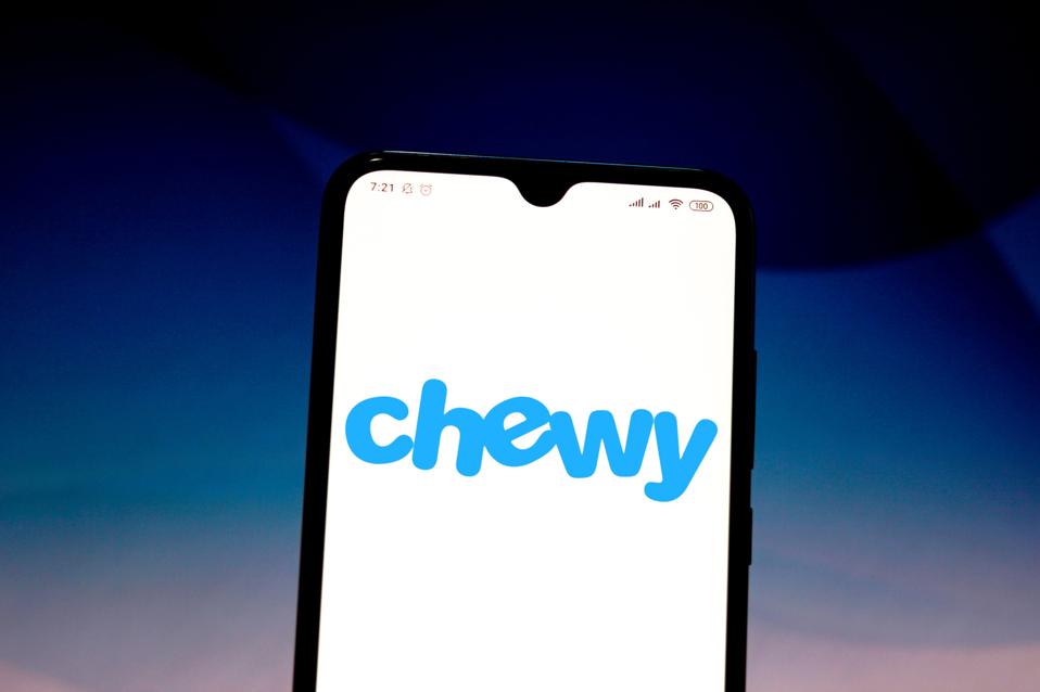 In this photo illustration the Chewy logo is seen displayed...