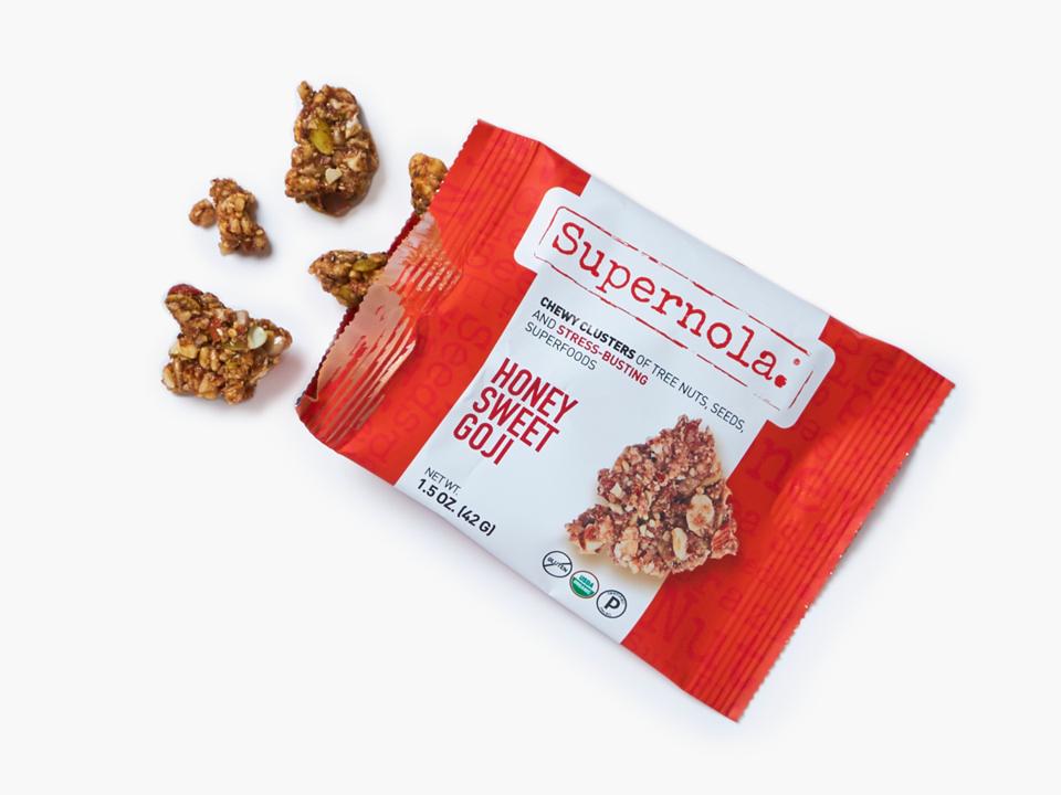 An open package of Supernola Honey Sweet Goji Clusters.