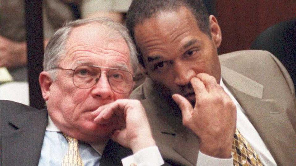 O.J. Simpson (R) whispers to Defense attorney F. L