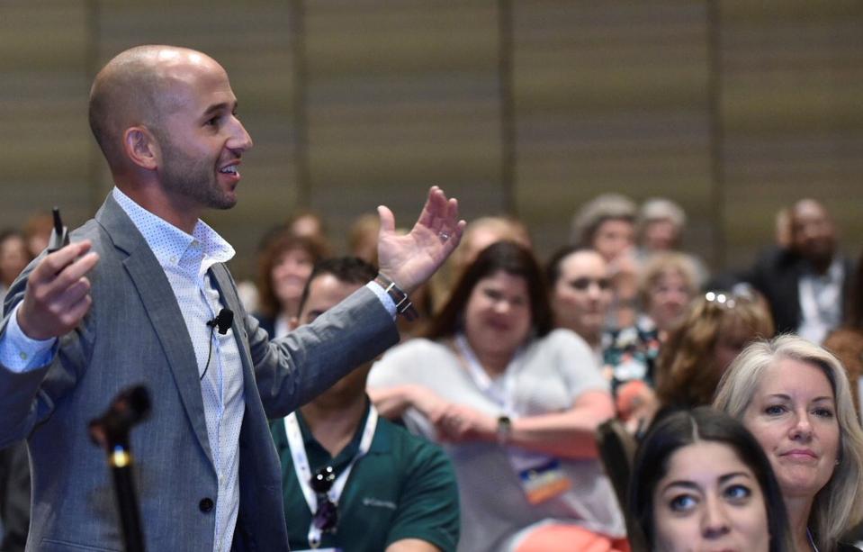 Zach Mercurio speaking to an audience.