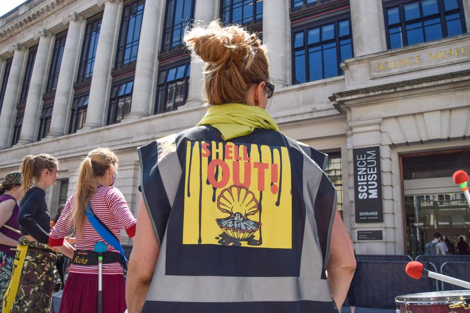 An Extinction Rebellion activist stands outside the Science...