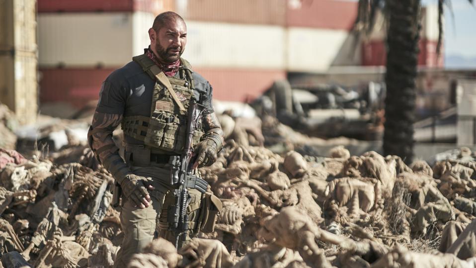 Dave Bautista stands amongst a pile of dead bodies in Army of the Dead
