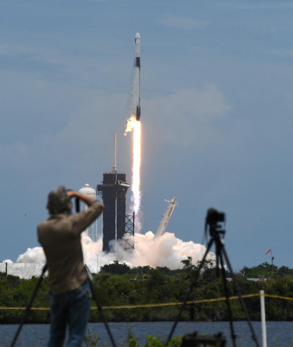 A SpaceX Falcon 9 rocket with a Dragon 2 spacecraft carrying...