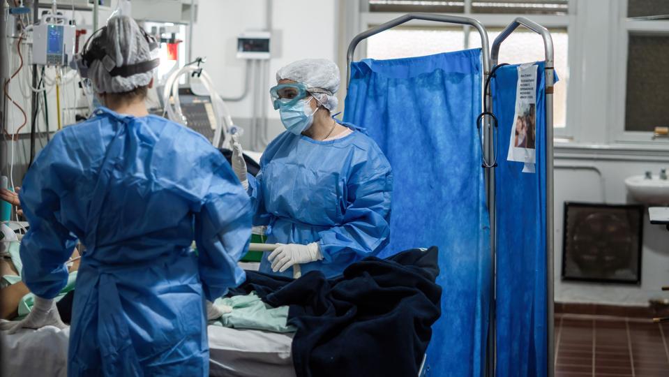 Nurses wearing Personal Protective Equipment suites (PPE)...