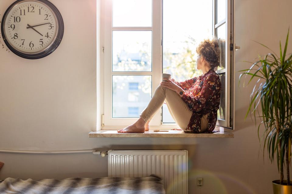 Young woman looking out of window