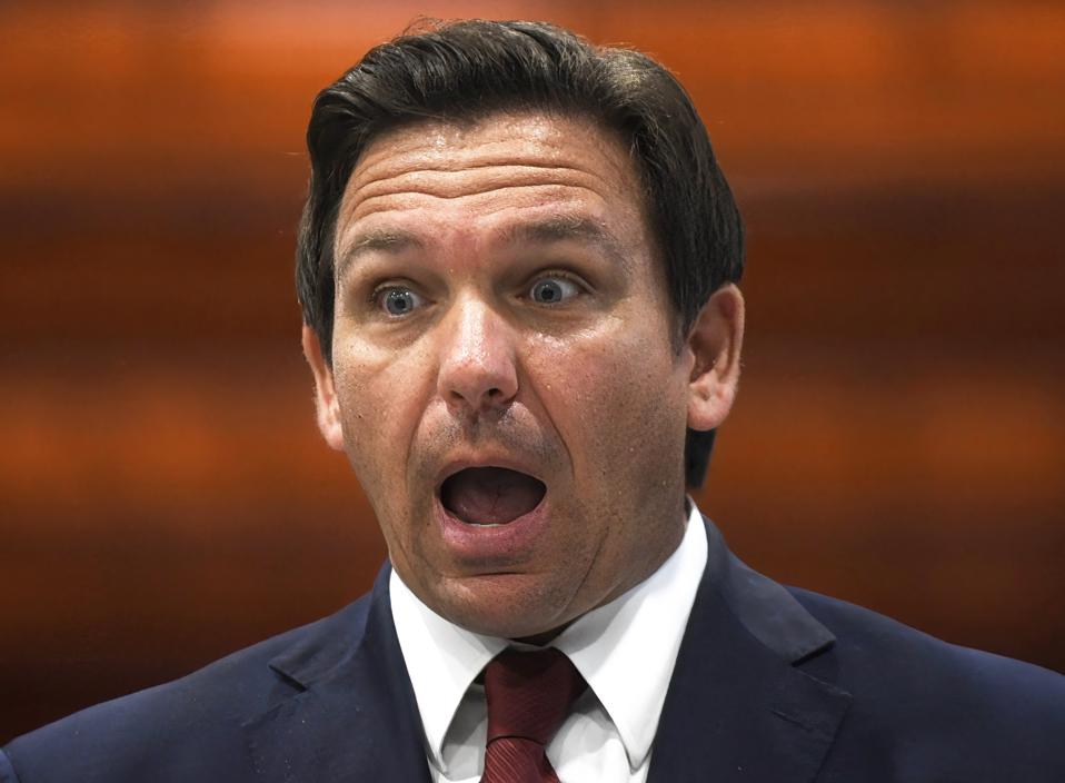 Florida Gov. Ron DeSantis reacts at a press conference at...