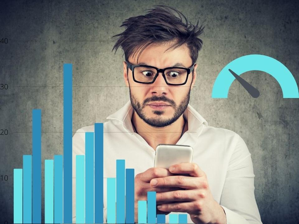 A man looks nervously into his cell phone as his crypto holdings decline in value.
