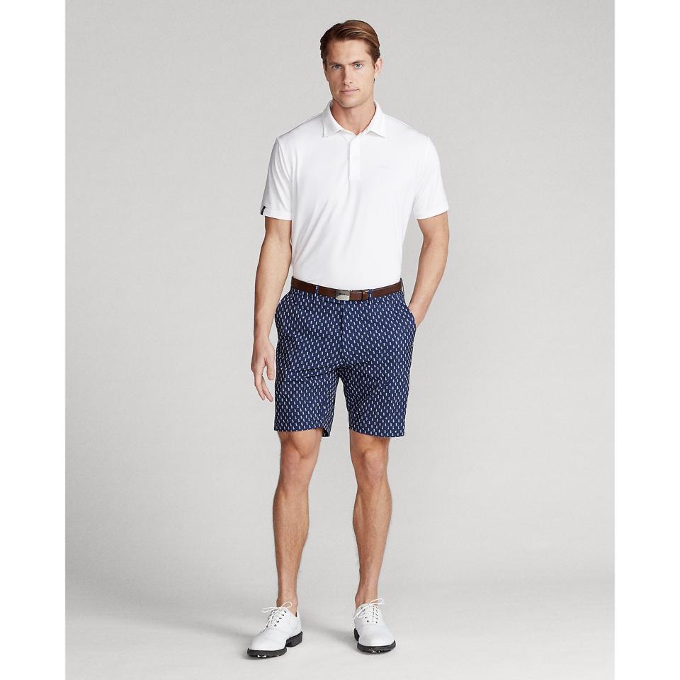Polo: Polo Golf—Custom Slim-Fit Performance Polo Shirt in White. $98.50 Shorts: RLX Golf- 9-Inch Classic Fit Water-Repellent Short in Punchy Pineapple $98.50.