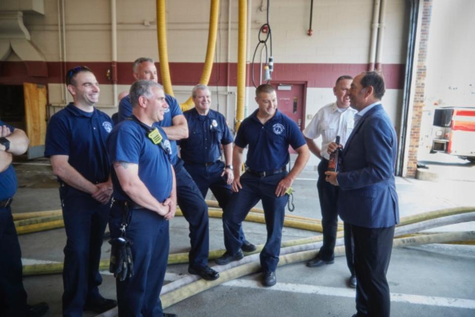 Josh Cellars founder Joe Carr presents a bottle of Cabernet Sauvignon to firefighters.