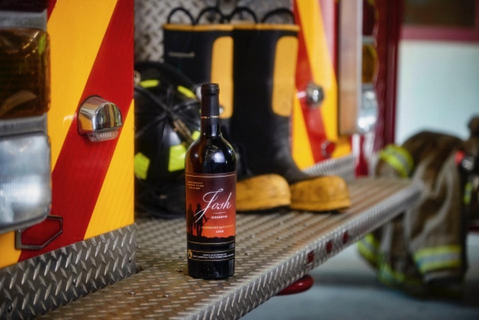 The 2019 Josh Cellars Reserve Lodi Cabernet Sauvignon label depicts two firefighters.