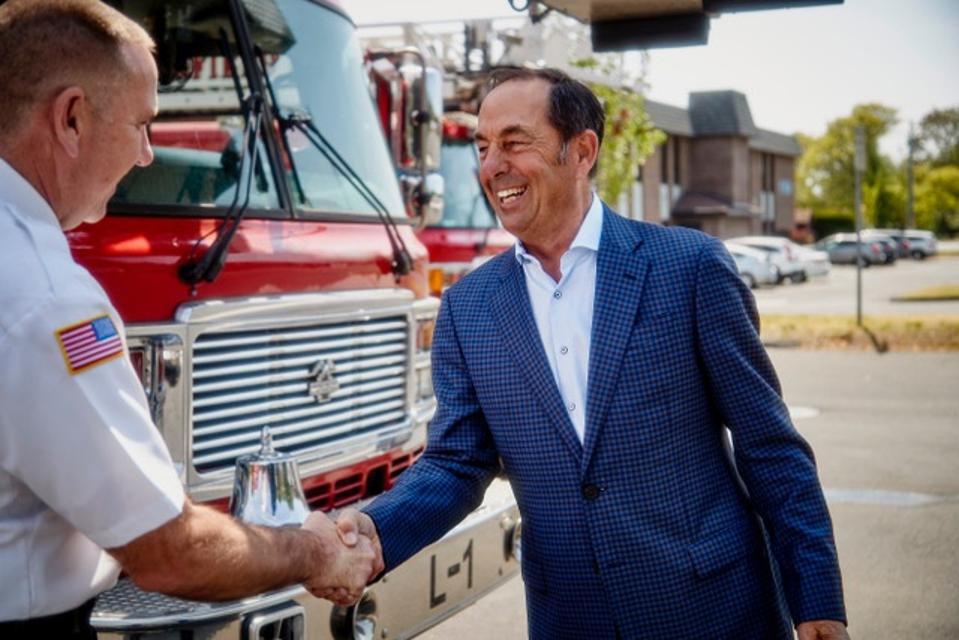 Josh Cellars founder Joe Carr shakes hands with the Springfield MA fire chief.