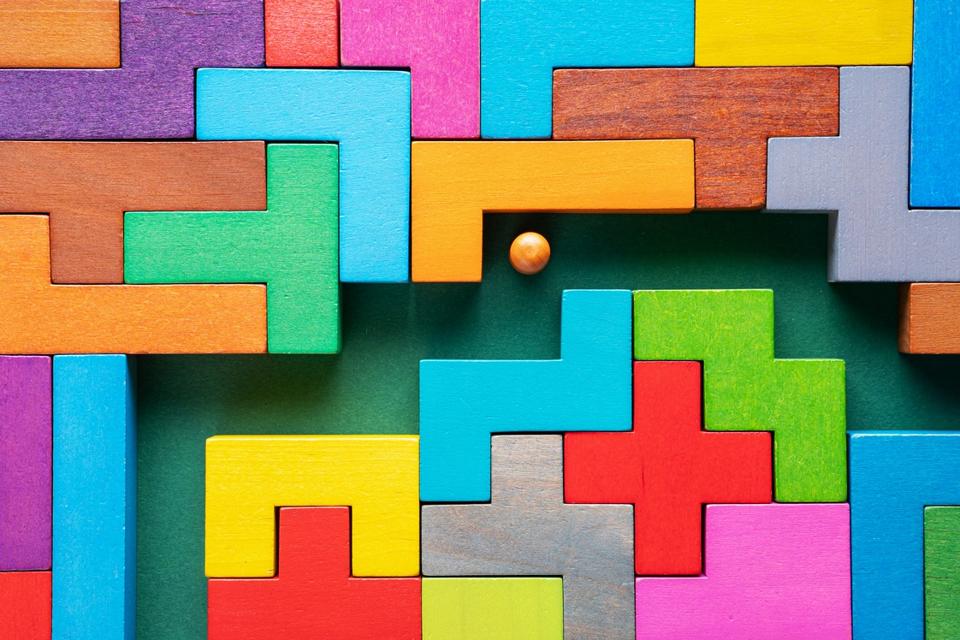 The concept of a business strategy, analytics, search for solutions, the search output. Labyrinth of colorful wooden blocks.