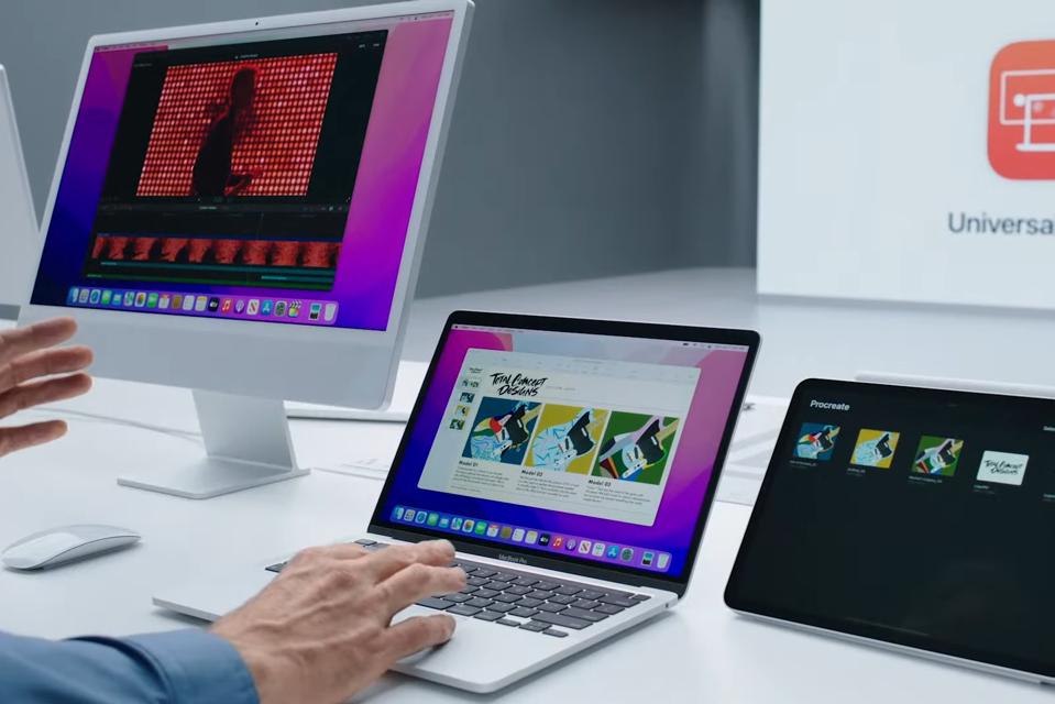iMac sitting next to Macbook Pro and iPad Pro using Universal Control feature.