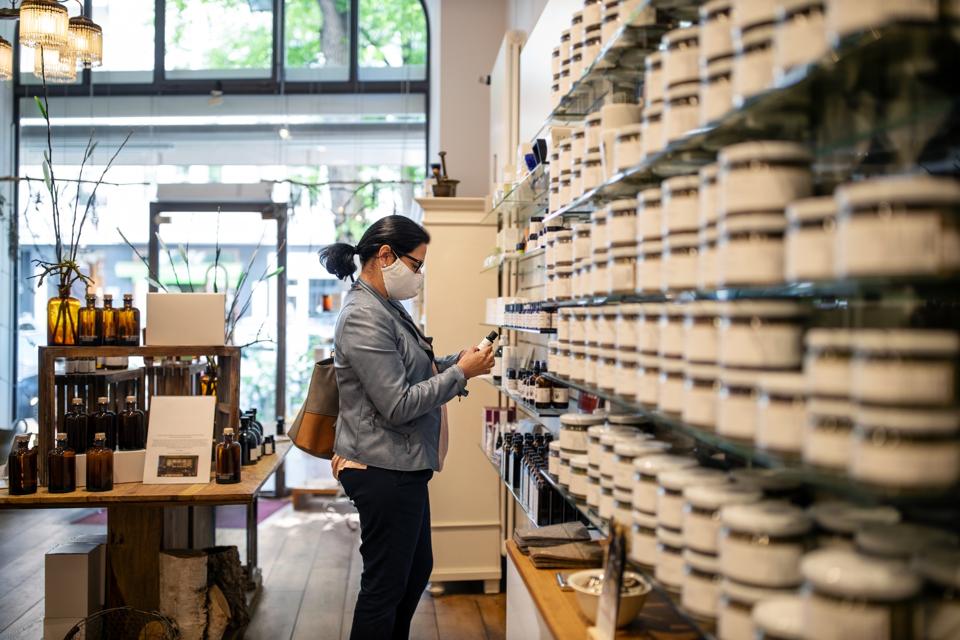Senior woman with face mask buying medicine at drugstore