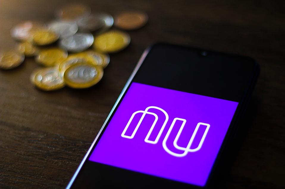 This photo illustration shows the Nubank logo...