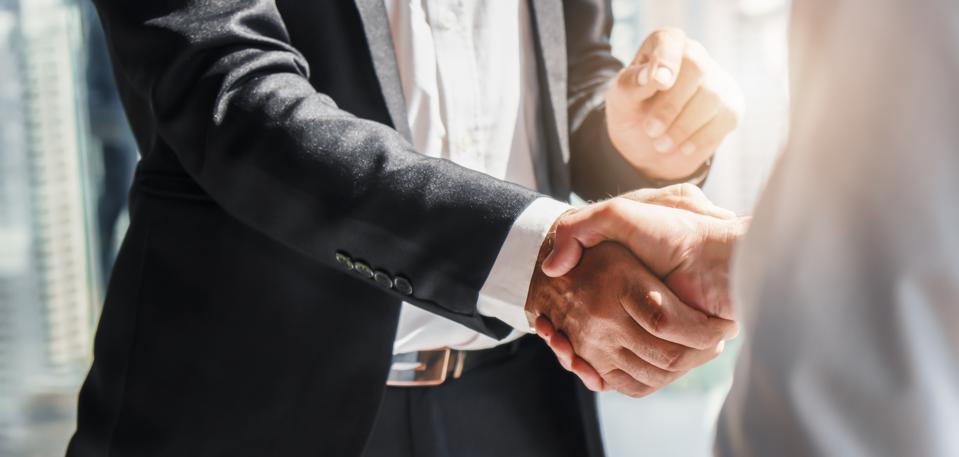 Business background of businessman having a handshake