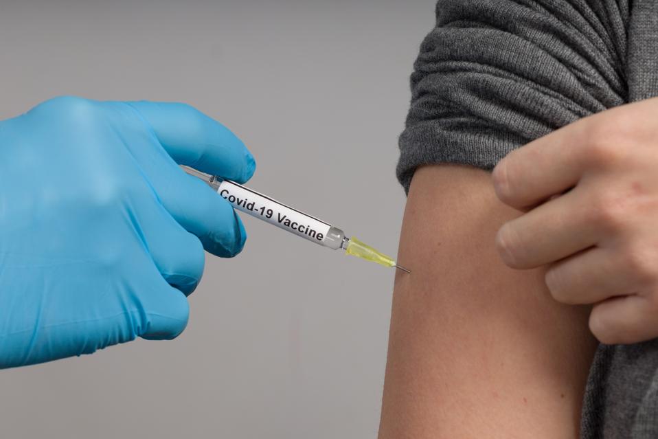 Close up of doctor's hand applying coronavirus vaccine