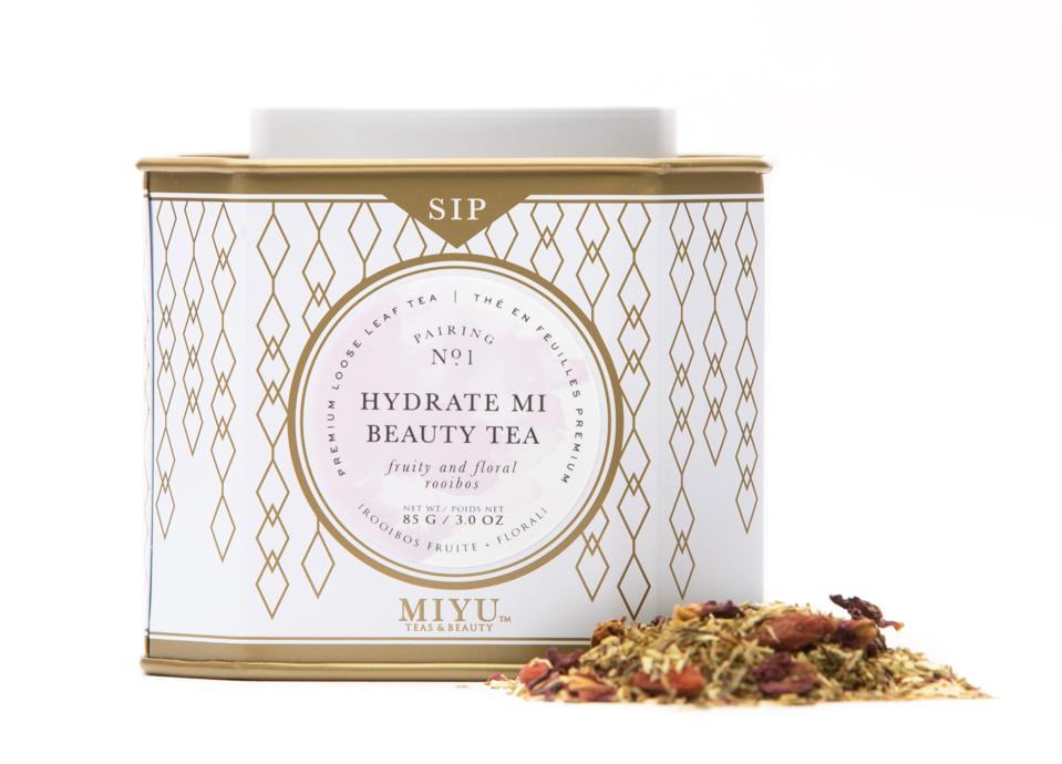Miyu Hydrate Mi Beauty Tea next to tea leaves. 