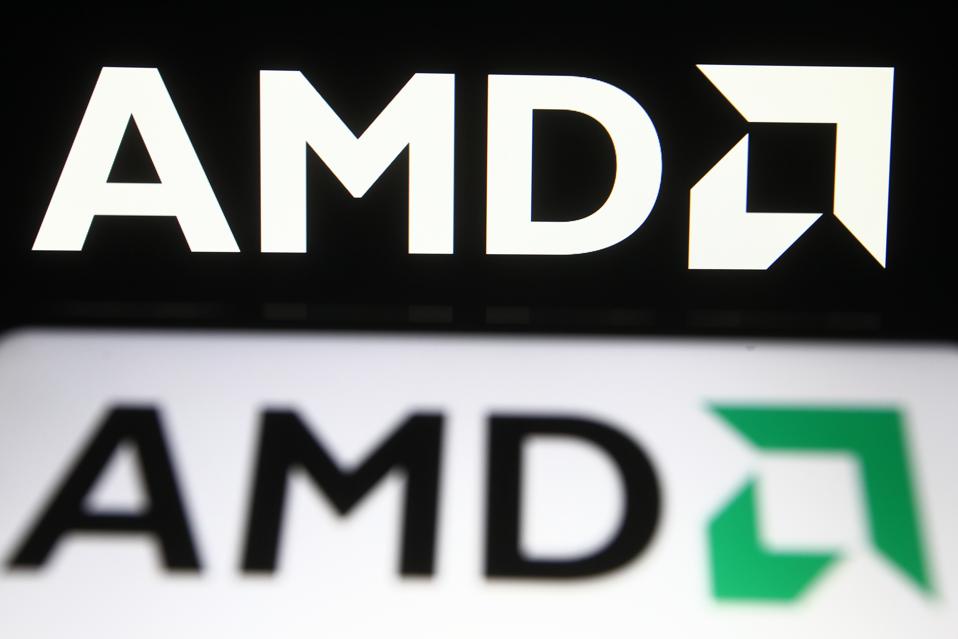 In this photo illustration, AMD logo is seen displayed on a...