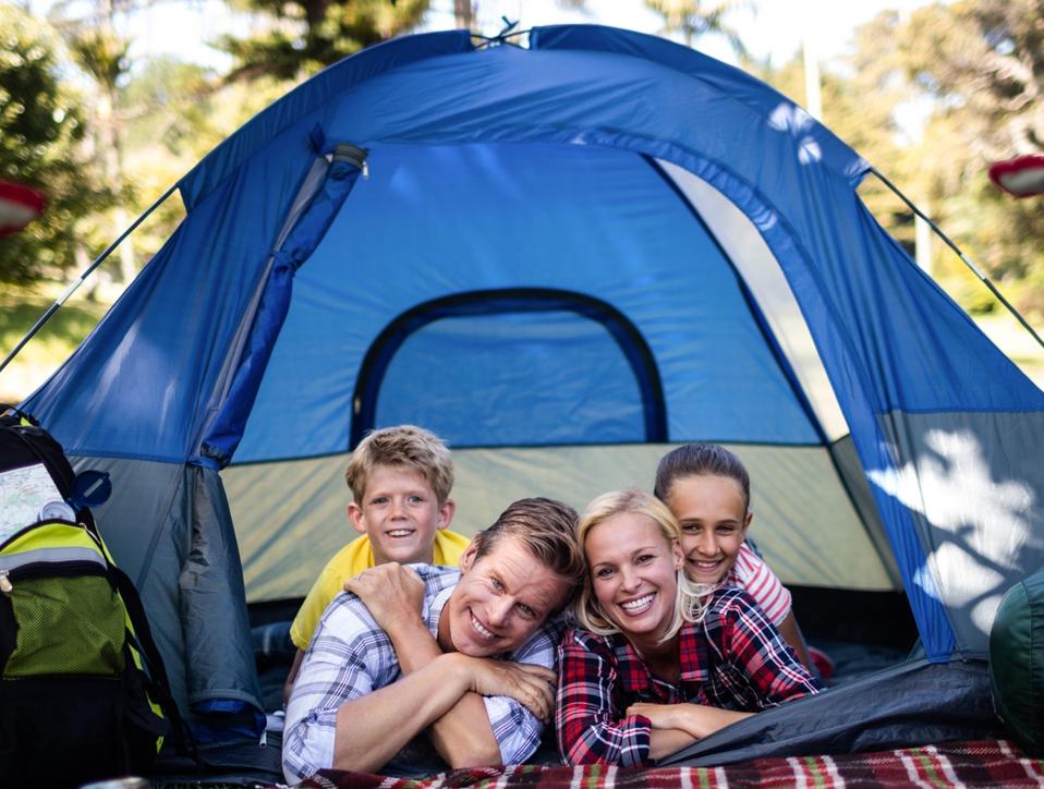 Happy family lying in a tent