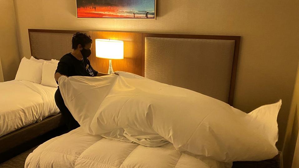 woman makes bed