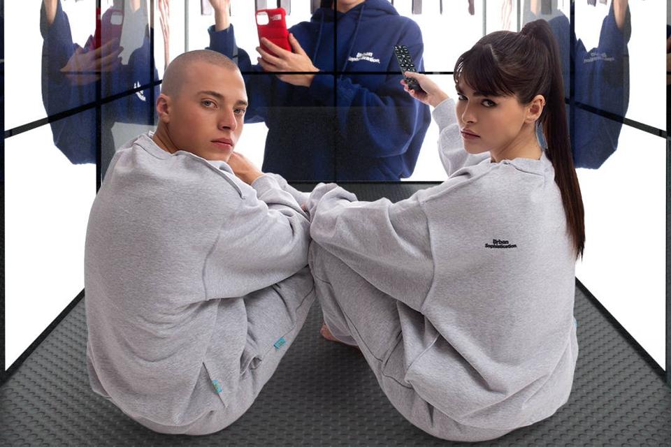Urban Sophistication ″Insecurity″ Sweatshirt worn by male and female models.
