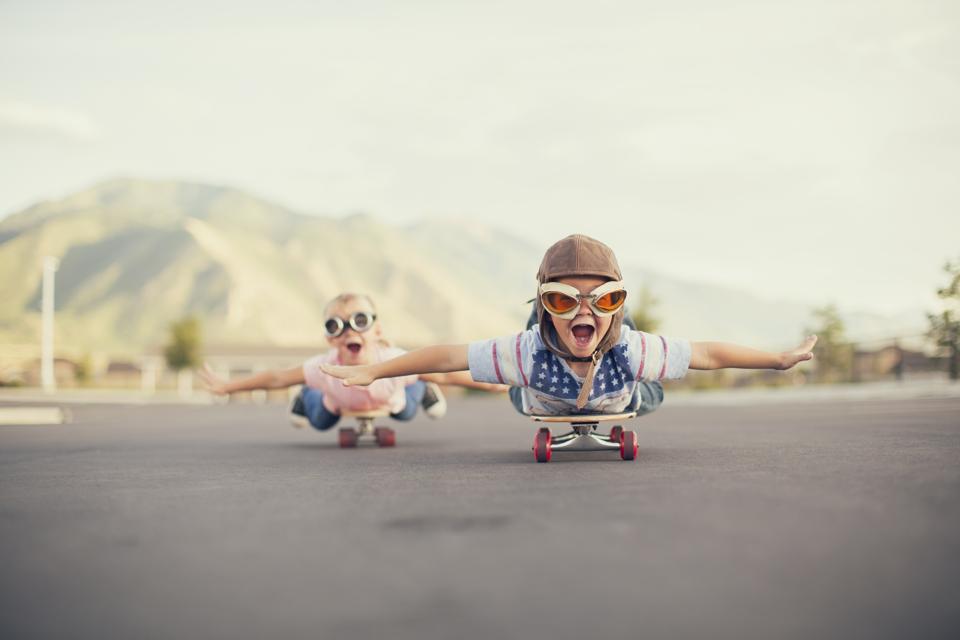 Kids imagine flying on skateboard, capturing the idea that play helps us to imagine.