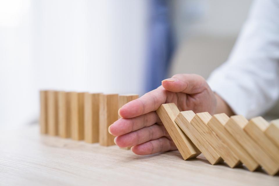 Stopping the domino effect concept for business solution, strategy and successful intervention