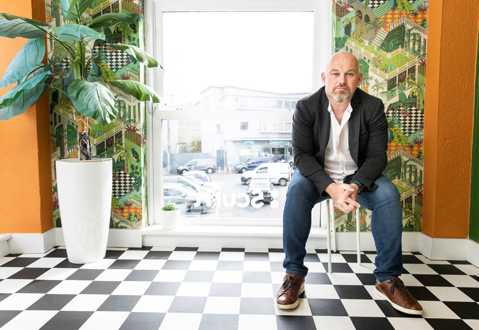 Scurri founder Rory O'Connor sitting in his company's office.