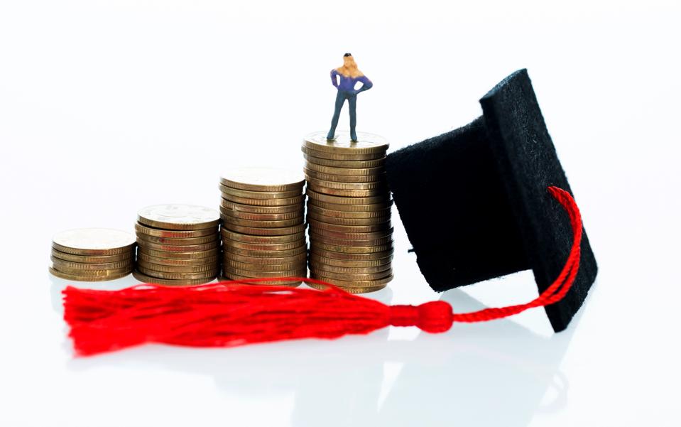 Graduation hat and figurine on coins
