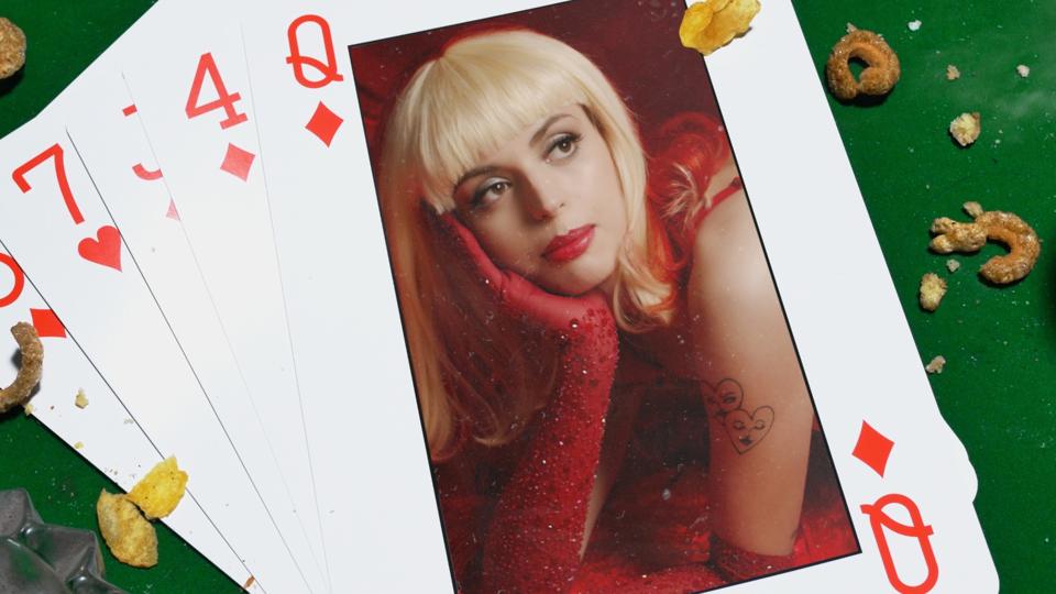 A screenshot of Rebecca Black in a playing card.