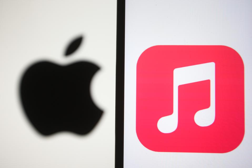 In this photo illustration, Apple Music app and Apple logo...