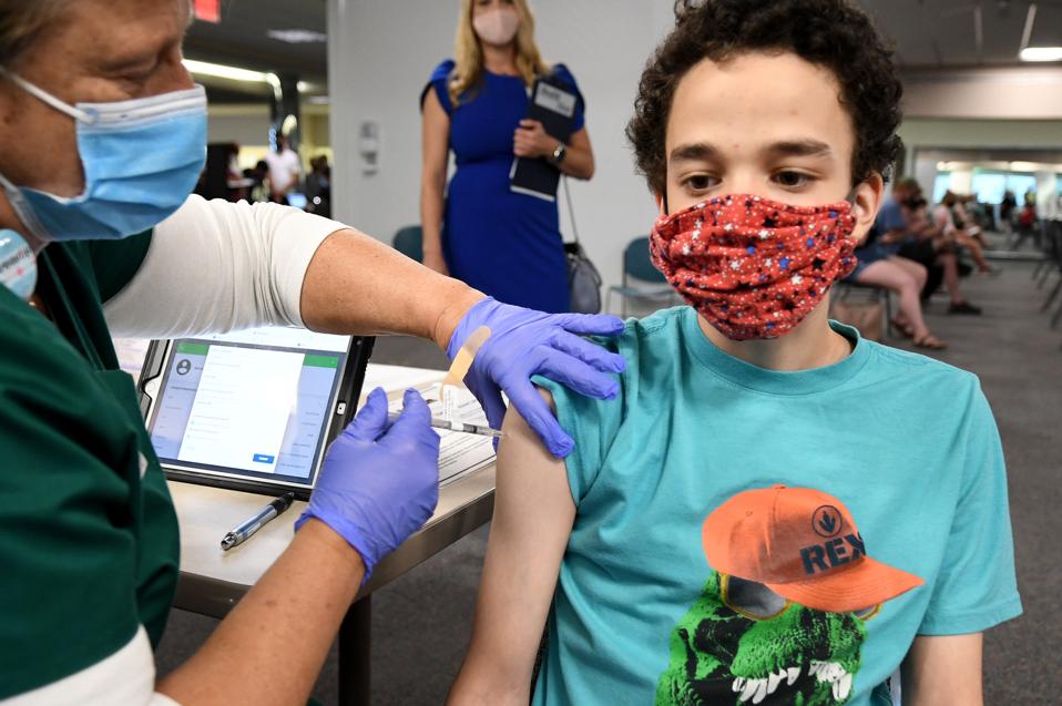 Teen receiving Covid-19 vaccine.