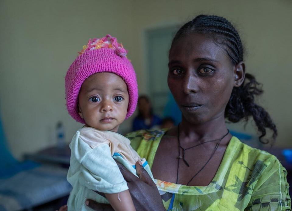 Yeshialem Gebreegziabher, 27, holds her 6-month-old daughter, Kalkidan Yeman, who is suffering from malnutrition, at Aby Adi Health Center in the Tigray region of northern Ethiopia, on June 7, 2021.