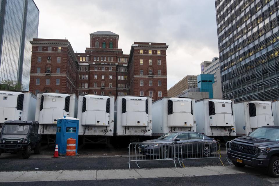 Freezer trucks across the city serve as mobile morgues to accommodate an onslaught of Covid-19 victims. The state is at its peak reporting over 1,000 new deaths a day.