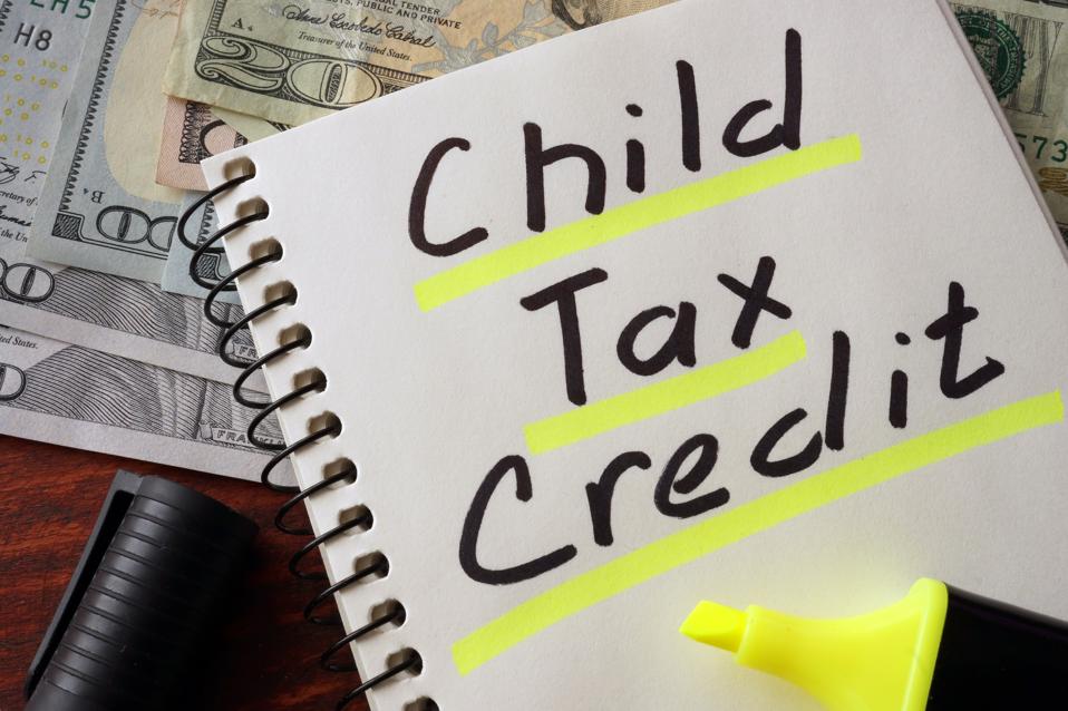 Notebook with child tax credit sign on a table.