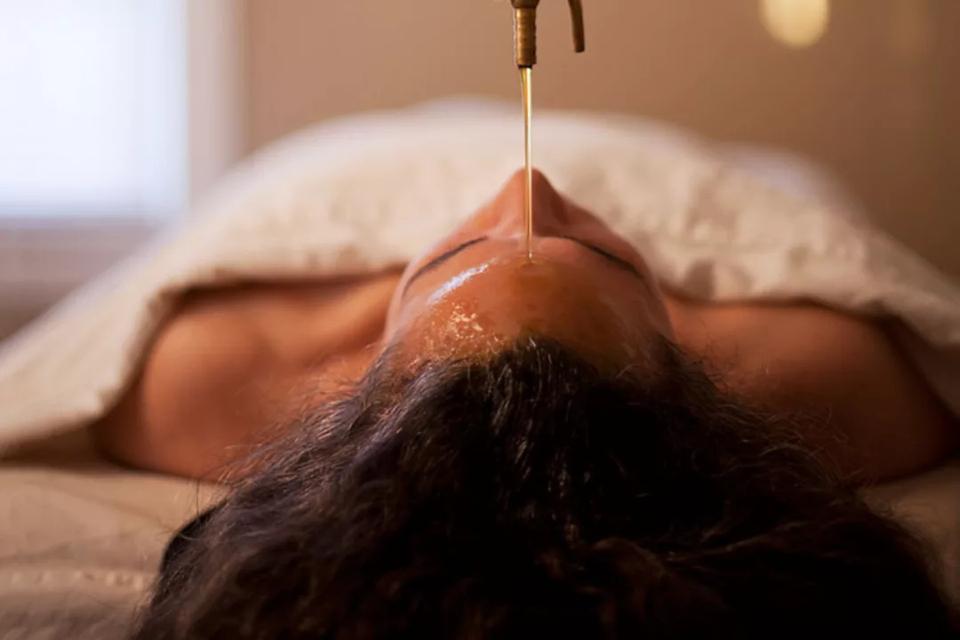 A person receiving a water treatment at a spa.